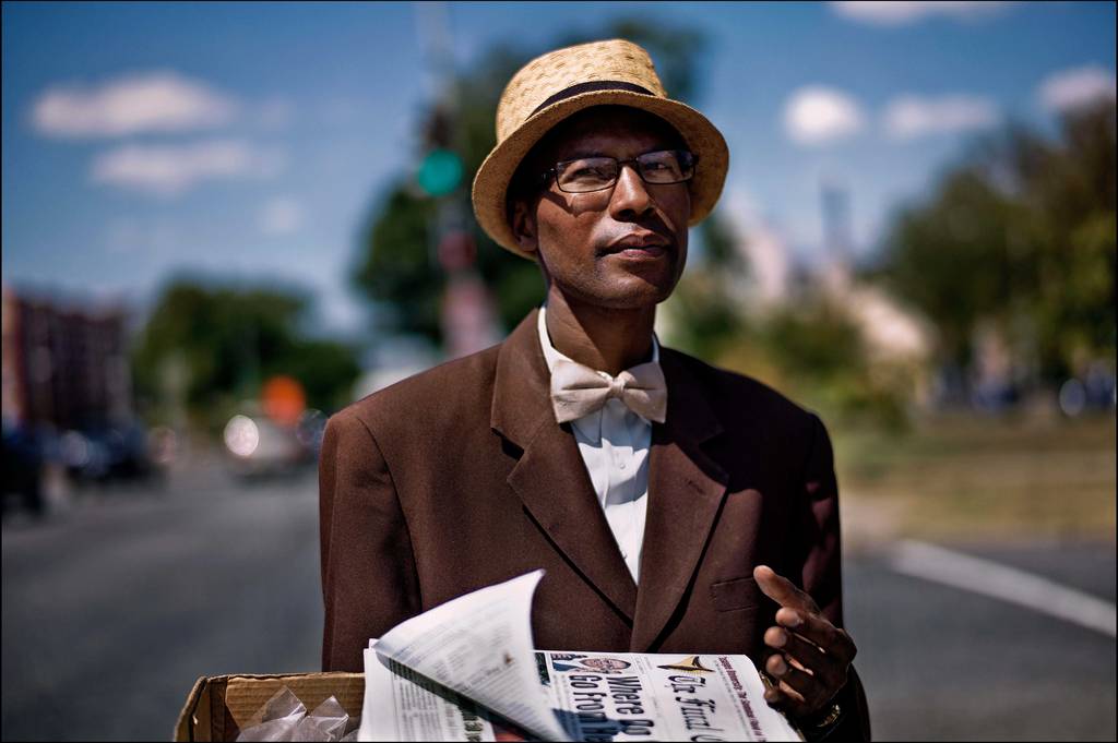 Copyright Sarah Lee - Pennsylvania Avenue Washington DC. Brother Burnell, who moved to the city two months ago. He finds it unfriendly but is staying optimistic. He sells copies of The Final Call [the Nation of Islam's newspaper] and bottles of insence on the street.