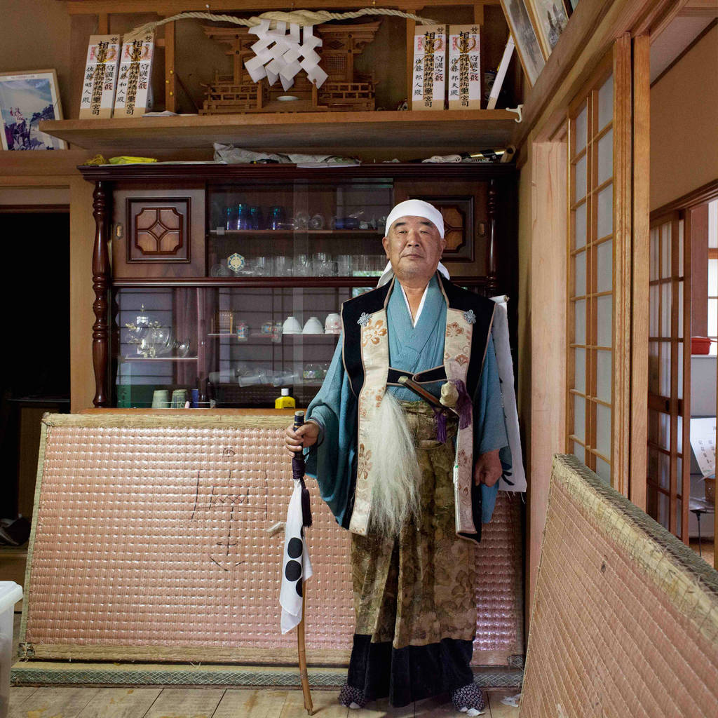 Kunio, 65 in front of a household altar sacred to Odaka Shrine "I used to stand in front of this kamidana (a household altar) sacred to Odaka Shrine and pray every morning when we were living here before the disaster.” He prayed when somebody in his family got sick, when his daughter-in-law gave birth and also for other occasions. Standing solemnly in front of the kamidana with gratitude as part of his daily routine was such a precious and calm moment for him. He cannot live here anymore but he prays to the kamidana whenever he visits here.  August 2012